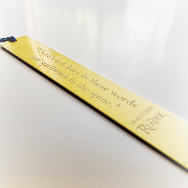 gold bookmark engraved with the words 