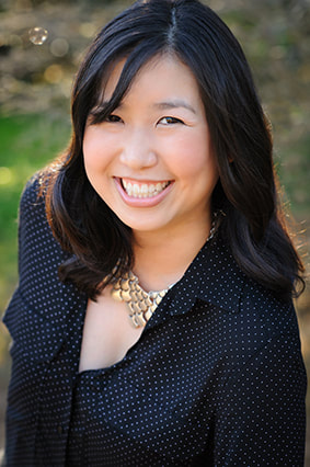 Picture of author Traci Chee looking up and smiling