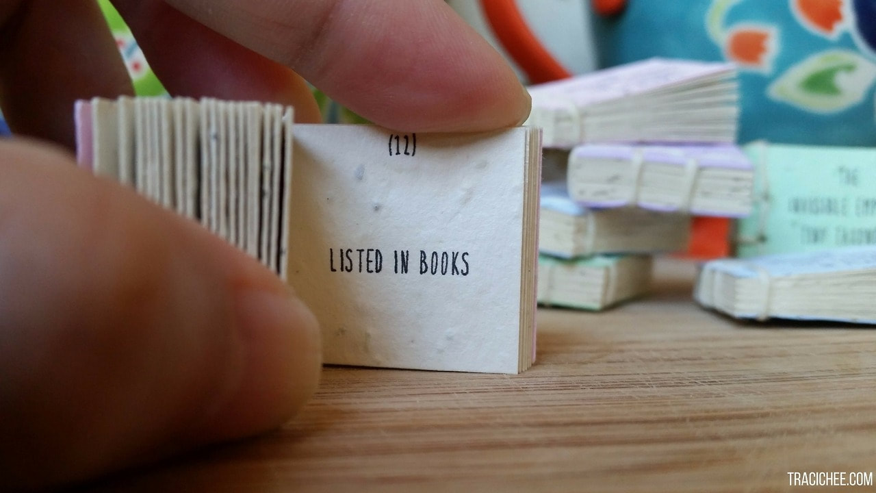 The tiny book reads 