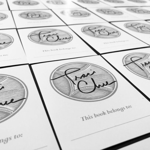 black and white photograph of signed bookplates for THE SPEAKER by Traci Chee