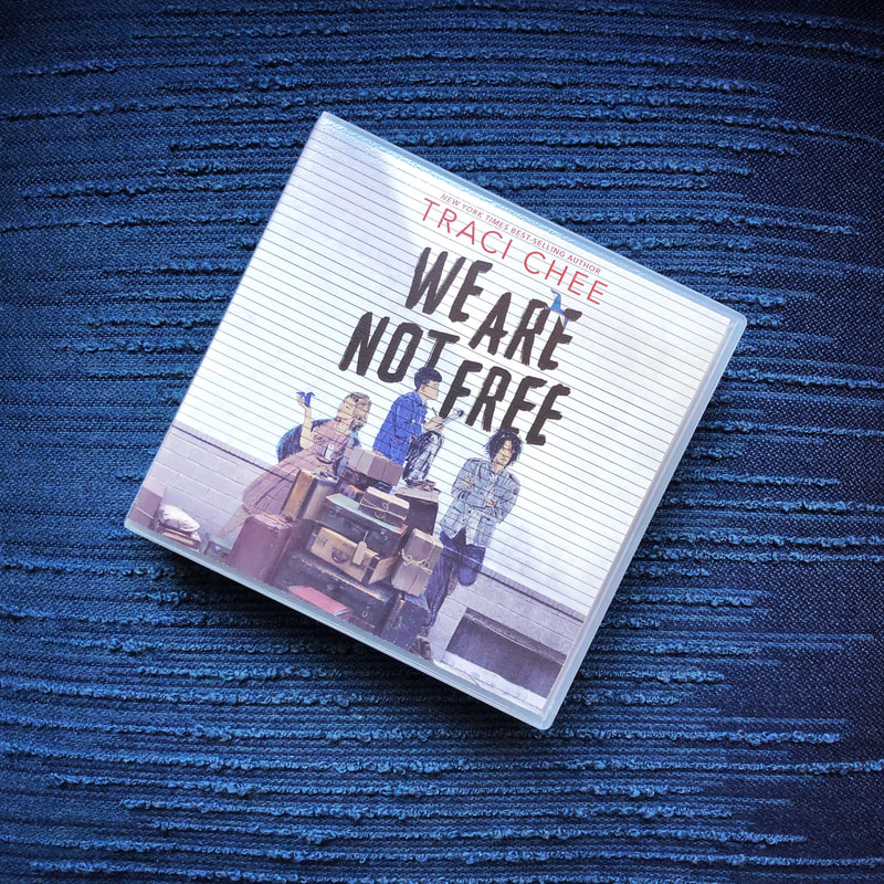 CD of the We Are Not Free audiobook on a blue embroidered background
