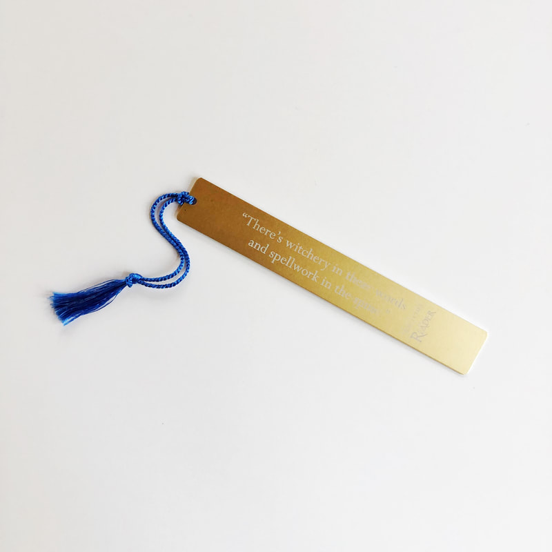 gold metal bookmark for the Reader Trilogy with blue tassel