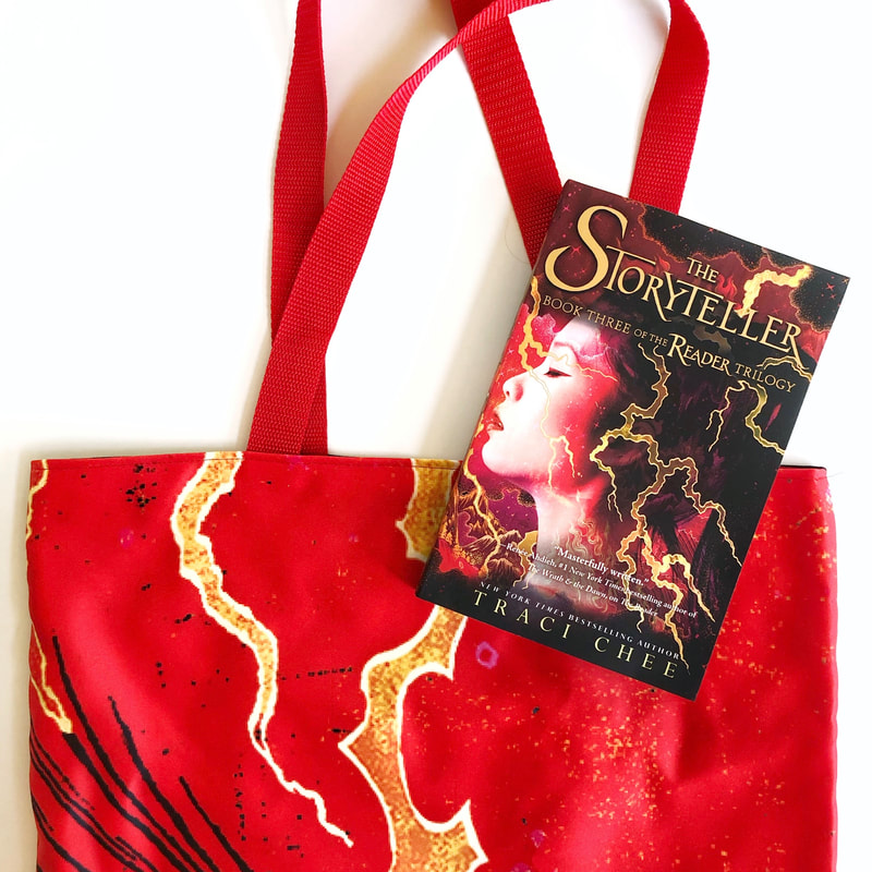 blazing red tote bag with a paperback copy of The Storyteller by Traci Chee