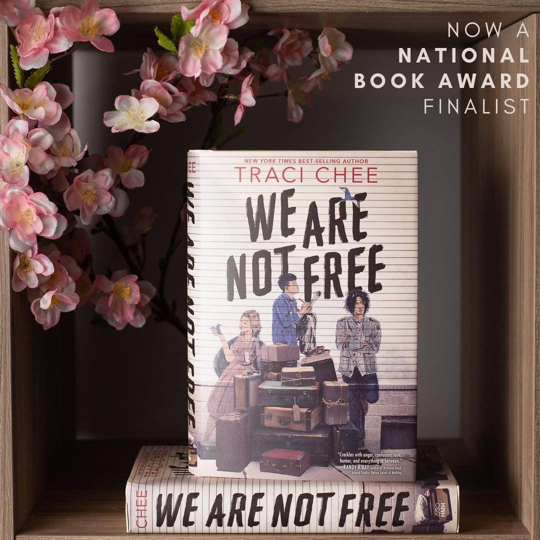 Part of a book cover with old luggage piled up and teenagers graffitied onto the wall behind. Caption: Exclusive: We Are Not Free Cover Reveal & Excerpt