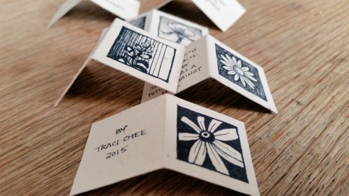 photo of small folded pages with drawings of common garden flowers